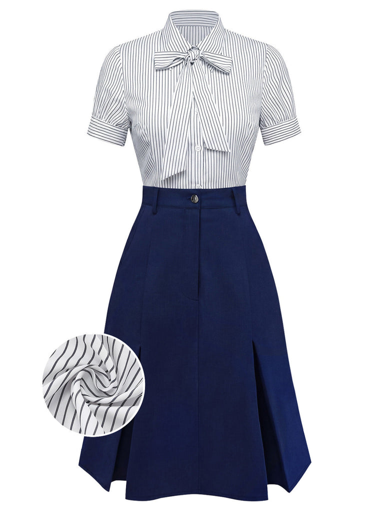 Ein professionelles zweiteiliges Outfit bestehend aus einer weißen, nadelgestreiften, kurzärmeligen Bluse mit Bindekragen, die in einen hochtaillierten, marineblauen ausgestellten Rock gesteckt ist.
