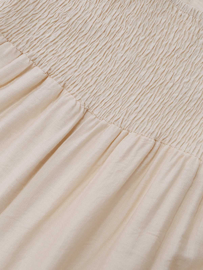 Beiger 70er Jumpsuit mit Häkelspitze und Fransenbesatz