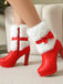 Weihnachtsstiefeletten mit Kunstfellbesatz, Schleifen und Blockabsatz