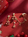 Rote asymmetrische Weihnachts-Ohrhänger mit Glöckchen, Sternen und Kettchen