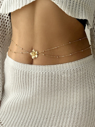 Goldener Body mit Blumen und Perlen