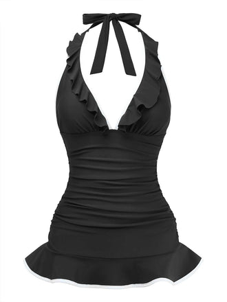 Studioaufnahme von vorne des schwarzen Neckholder-Badeanzugs mit tiefem V-Ausschnitt und Rüschen sowie einem schmeichelhaften, ausgestellten Saum im Skater-Stil.
