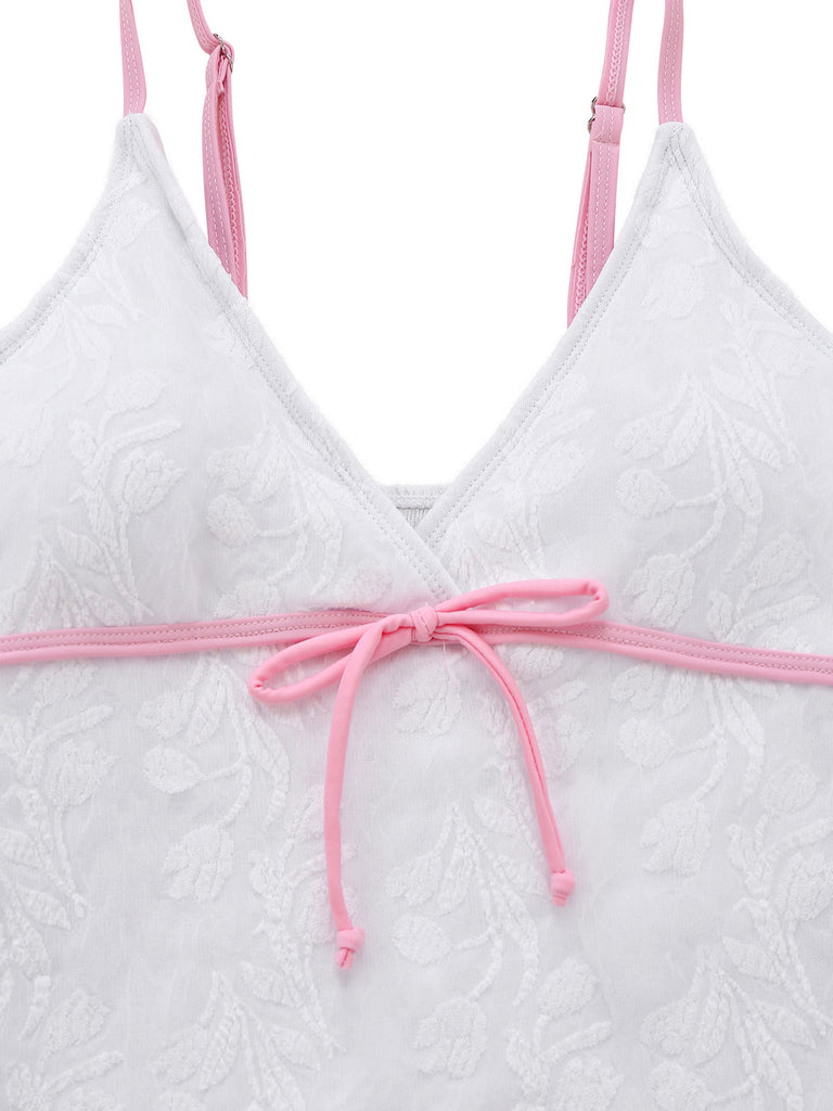 Weißer, strukturierter Badeanzug mit rosa Trägern auf weißem Hintergrund