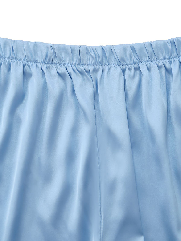 Nahaufnahme des dehnbaren Gummibundes und der feinen Nähte an den seidigen Satinshorts.