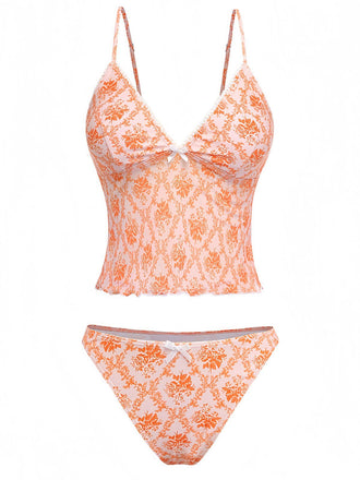 Retro-Tankini in Orange mit tiefem V-Ausschnitt und verspieltem Blumenmuster im 70er-Jahre-Stil, ideal für Sommerurlaube und Poolpartys im Vintage-Stil.