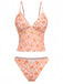 Retro-Tankini in Orange mit tiefem V-Ausschnitt und verspieltem Blumenmuster im 70er-Jahre-Stil, ideal für Sommerurlaube und Poolpartys im Vintage-Stil.