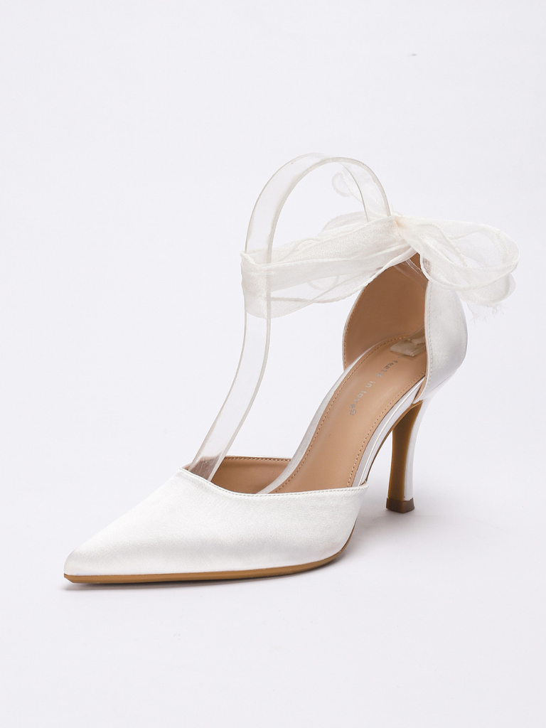 Weißer High Heel mit Schleife auf weißem Hintergrund